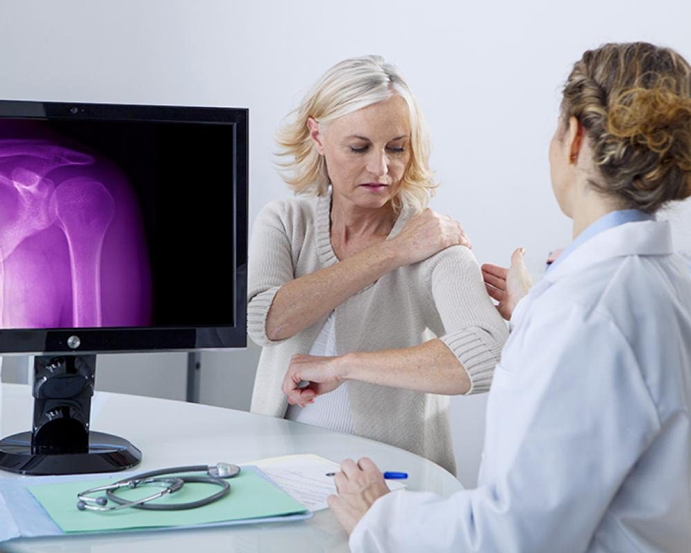 Bonus Infographic: Orthopedic surgeon discussing shoulder arthroscopy treatment options with a patient. 